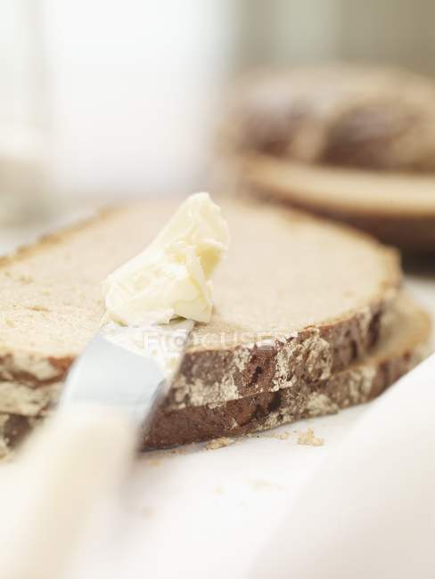 Шматочки хліба і ножа з маслом — стокове фото