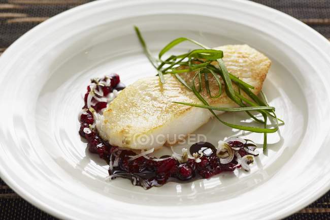 Halibut with seed oil and lingonberry sauce — Stock Photo