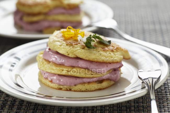 Closeup view of blinis with lingonberry cream — Stock Photo