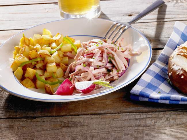 Fried potatoes with sausage salad — Stock Photo