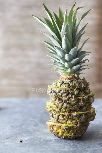 Sliced pineapple on grey surface — Stock Photo