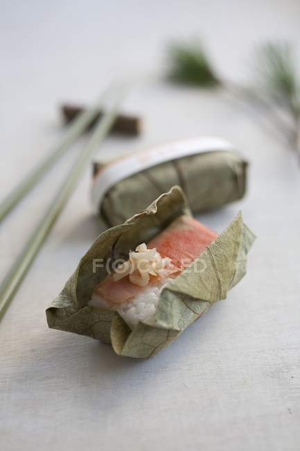 Salmon sushi wrapped in leaf — Stock Photo