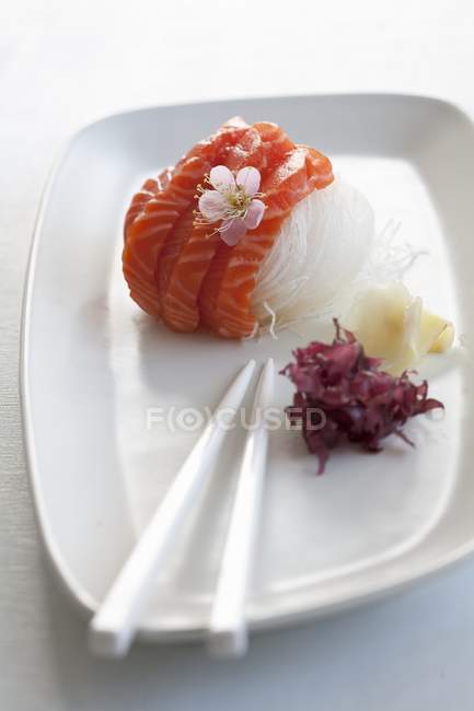 Salmon sashimi on radish strips — Stock Photo