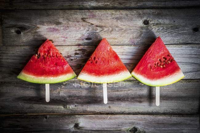 Watermelon slices on sticks — Stock Photo