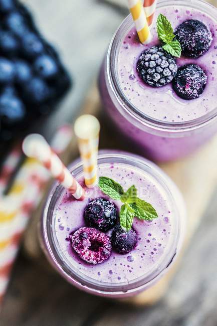 Berry smoothies in jars — Stock Photo