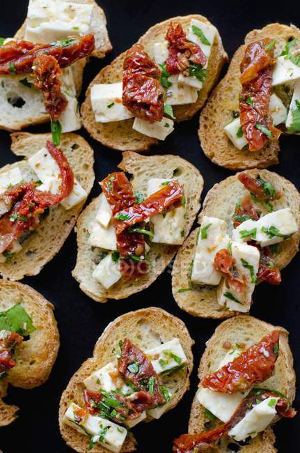 Bruschetta topped with cheese — Stock Photo