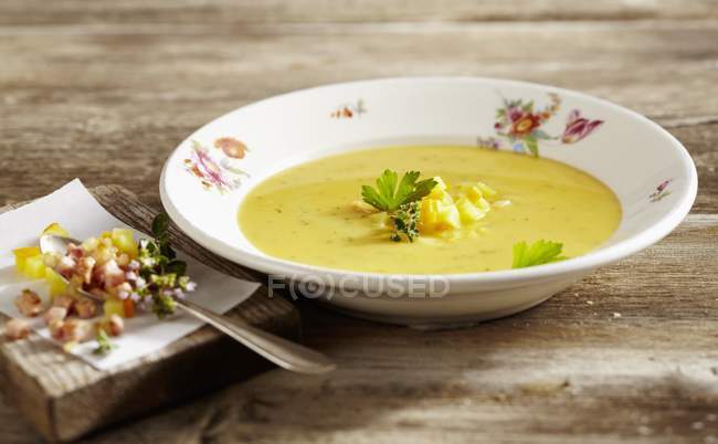 Lusatian potato soup with chasseur sausage on white plate  over wooden surface — Stock Photo
