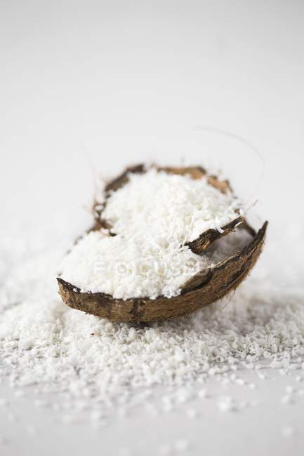 Flakes in coconut shell — Stock Photo