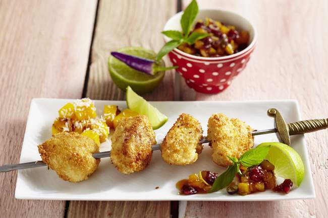 Closeup view of chicken skewers with cranberry salsa — Stock Photo