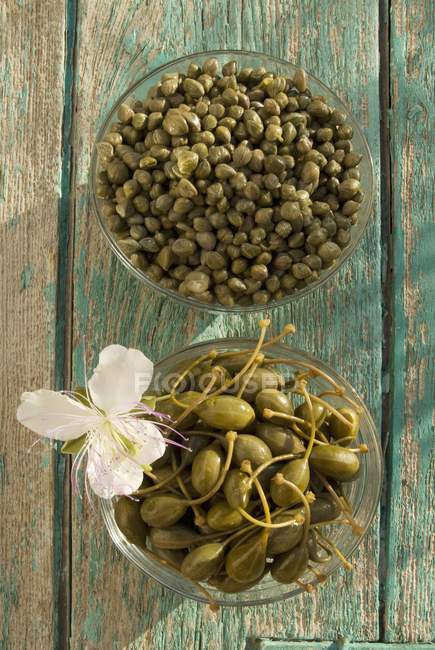 Capers in glass bowls — Stock Photo