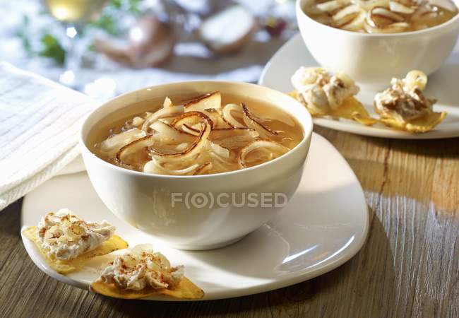 Onion soup in bowl with tortilla chips — Stock Photo