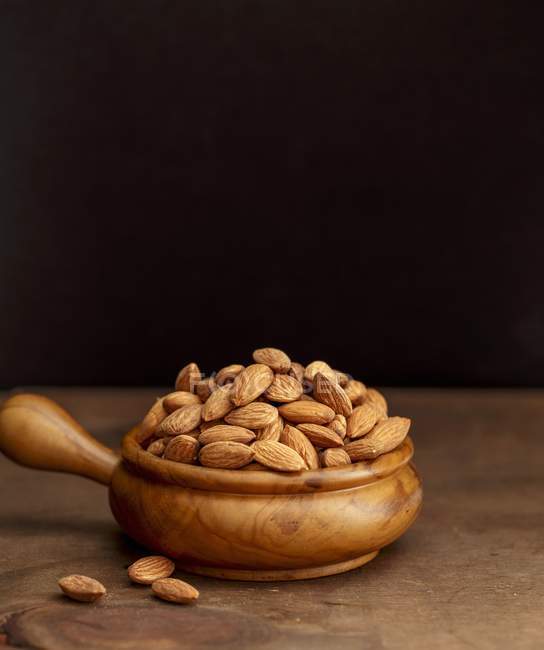 Almonds in wooden bowl — Stock Photo