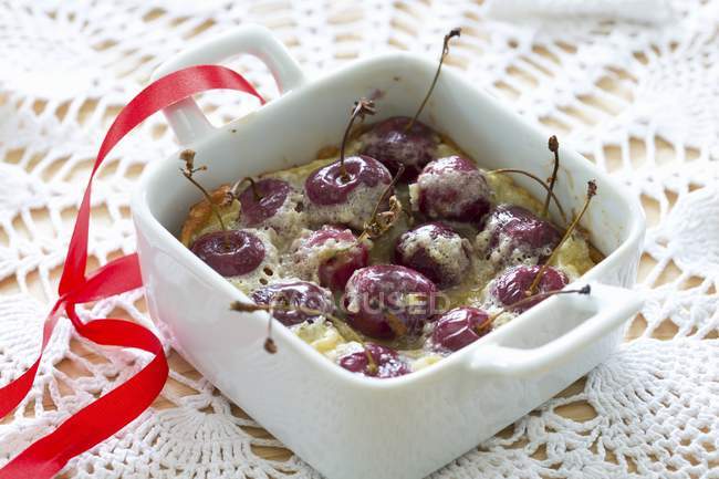 Closeup view of cherry clafoutis in a baking dish — Stock Photo