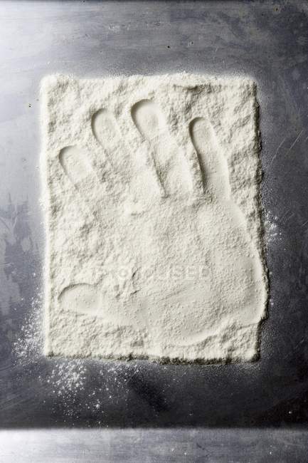 Hand print in wheat flour — Stock Photo