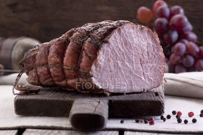 Smoked ham in net — Stock Photo