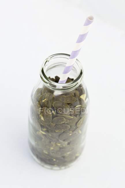 Pumpkin seeds in bottle — Stock Photo