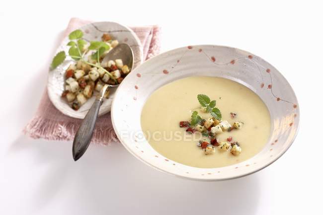 Coconut and turnip soup in bowl with croutons — Stock Photo