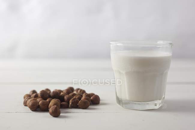 Glass of hazelnut milk — Stock Photo