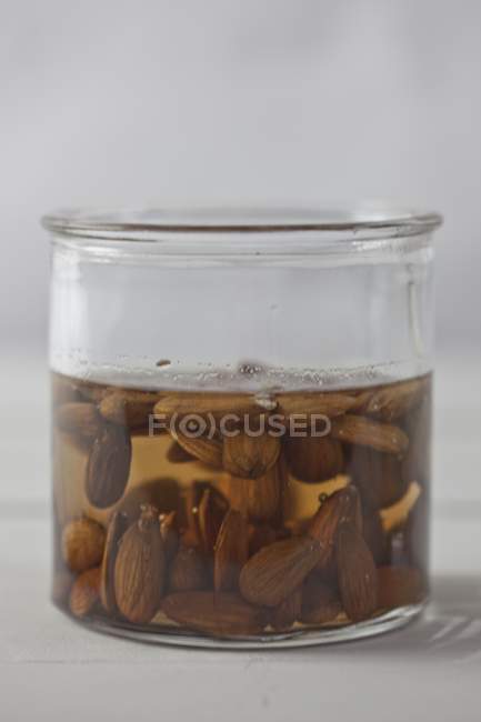 Almonds softened in water — Stock Photo