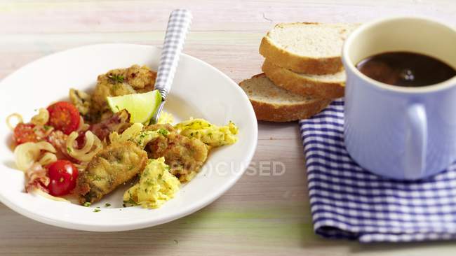 Hangtown Fry - omelette with ham and oysters  on white plate with spoon — Stock Photo