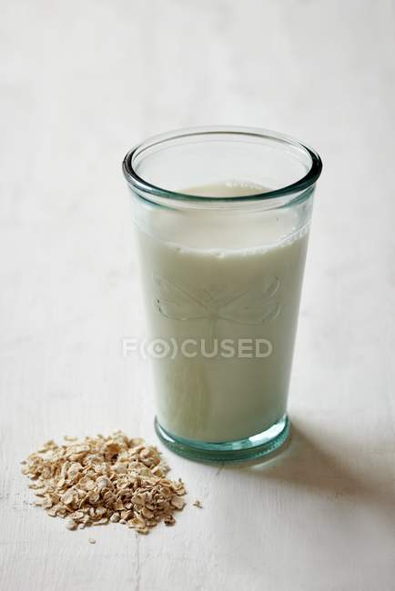 Oat milk on white surface — Stock Photo