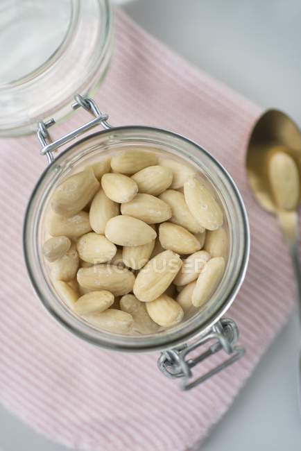 Jar of shelled almonds — Stock Photo