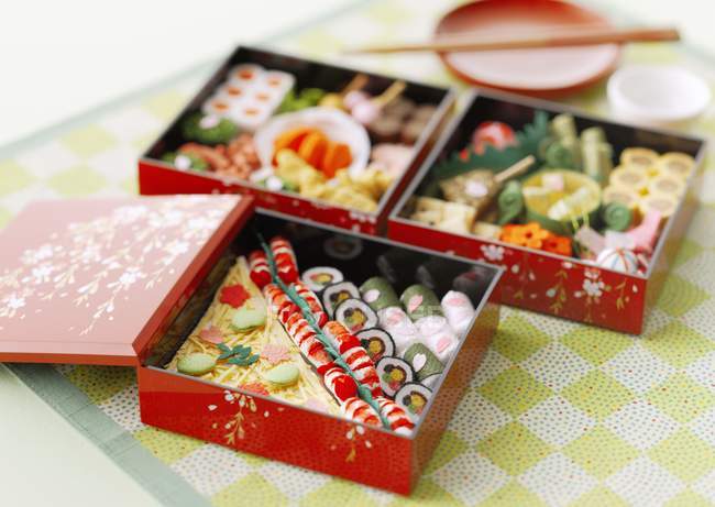 Elevated view of Japanese lunch boxes with rolls — Stock Photo