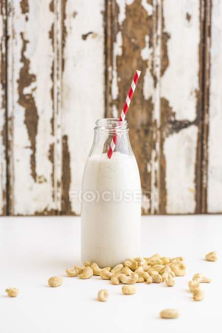 Cashew nuts and bottle — Stock Photo