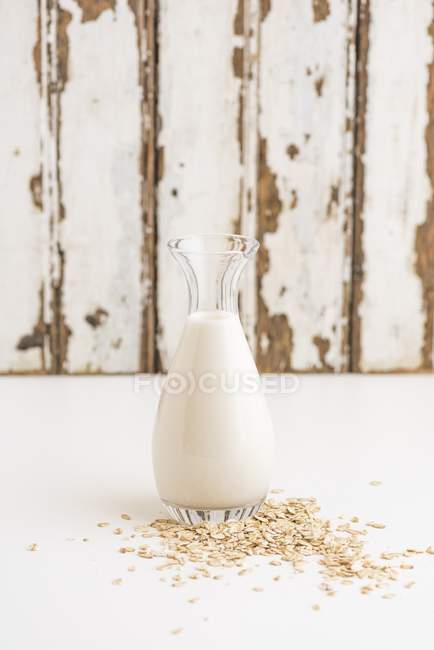 Oats and a bottle of milk — Stock Photo