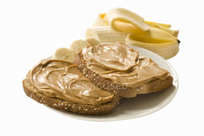 Banana and slices of bread — Stock Photo
