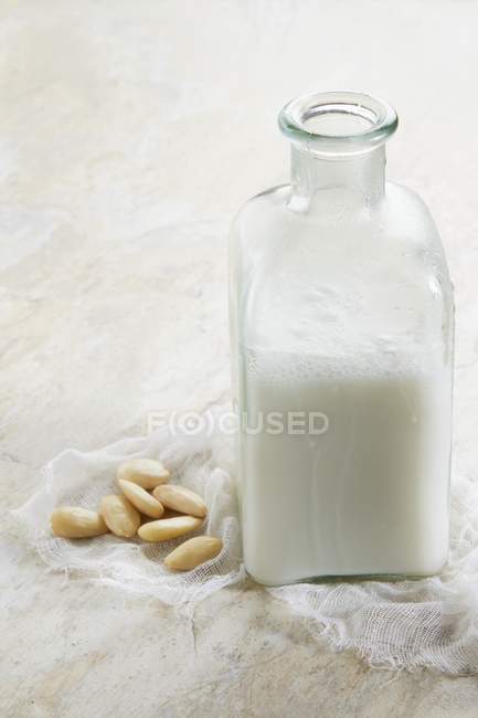 Almond milk and almonds — Stock Photo