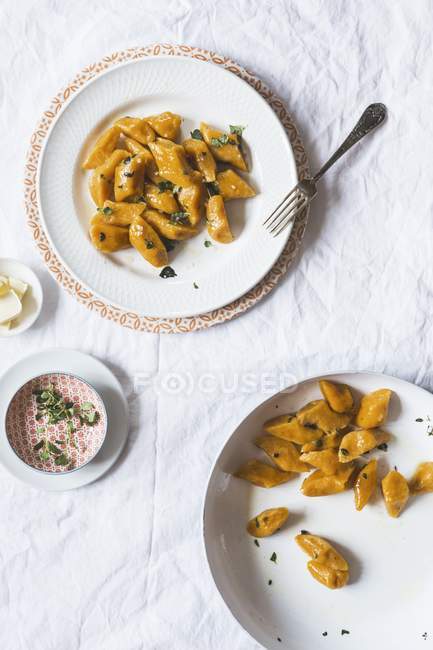 Polish sweet potato dumplings in white plate with fork — Stock Photo