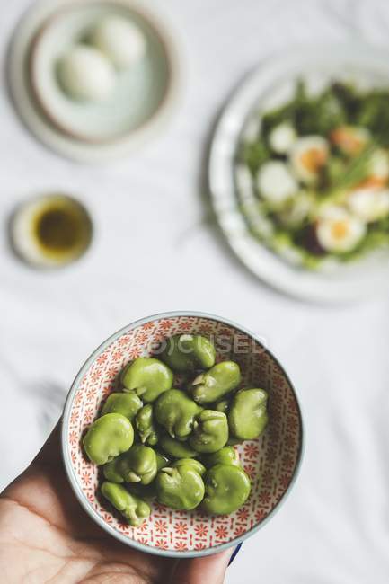 Broad beans as ingredients for salad with salmon — Stock Photo
