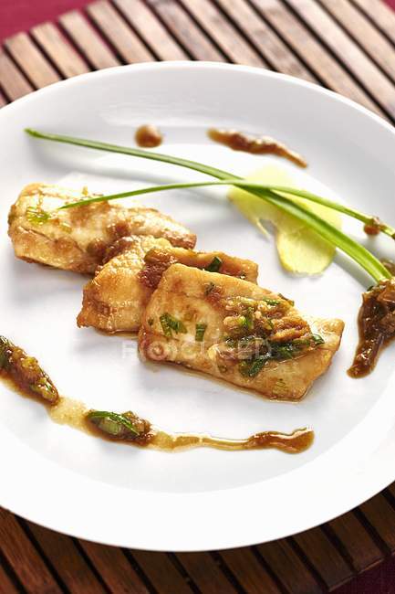 Hake fillet with sauce — Stock Photo