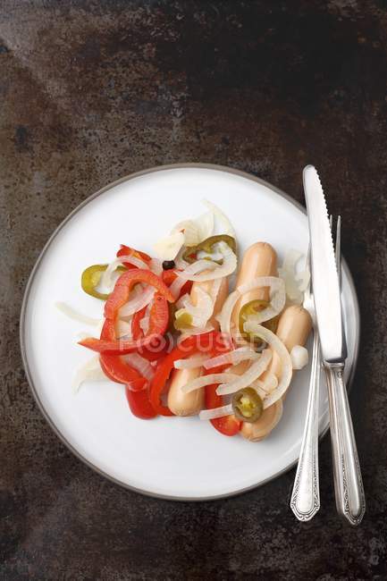 Sausages pickled with onions — Stock Photo