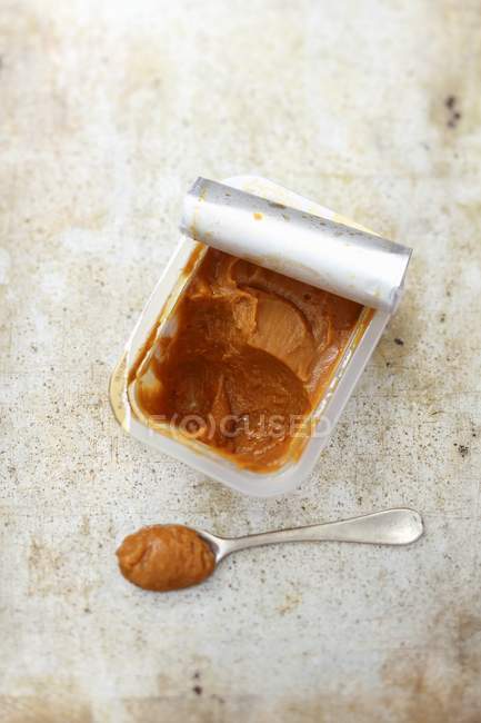 Top view of Miso paste in plastic dish and on spoon — Stock Photo