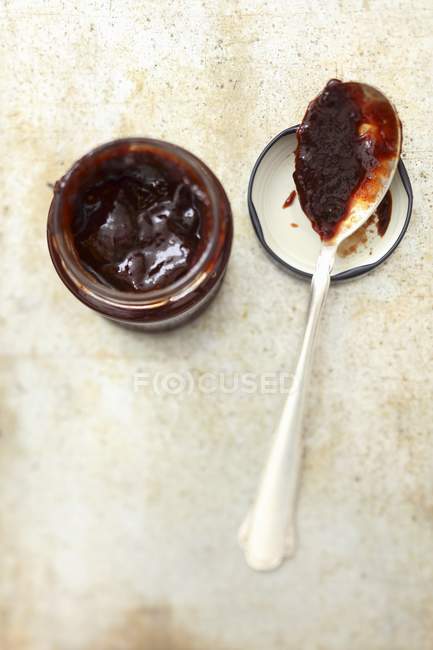 Plum jam in jar with spoon — Stock Photo
