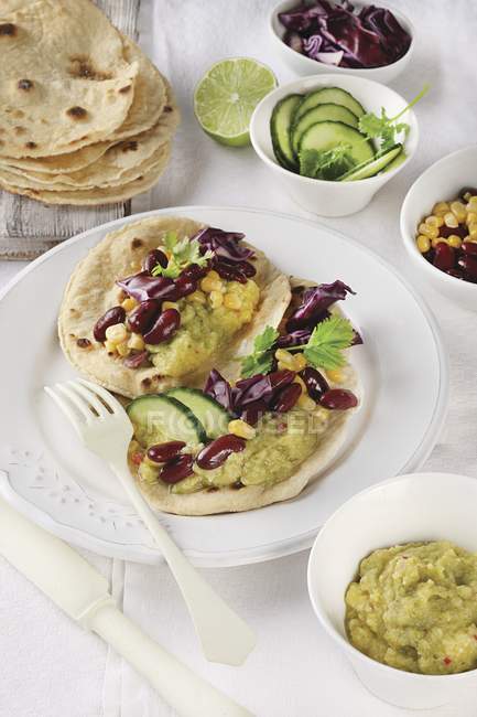 Tortilla e envolve com legumes e nata de abobrinha em prato branco com garfo — Fotografia de Stock