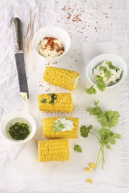 Corn cobs with dips — Stock Photo