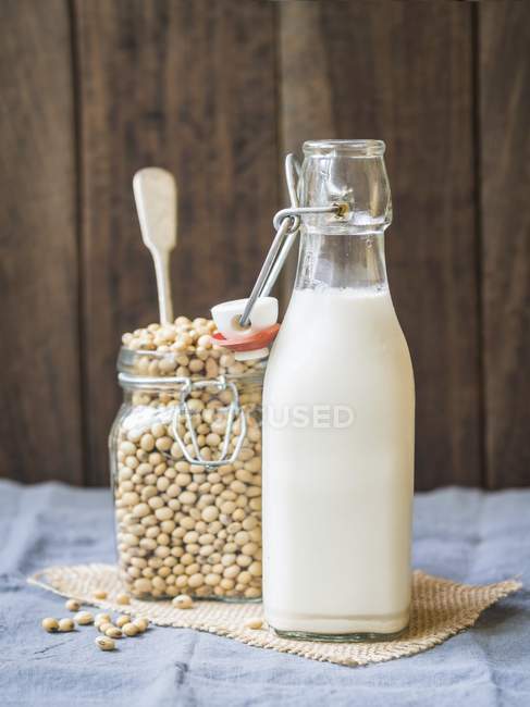 Soy milk and soybeans — Stock Photo
