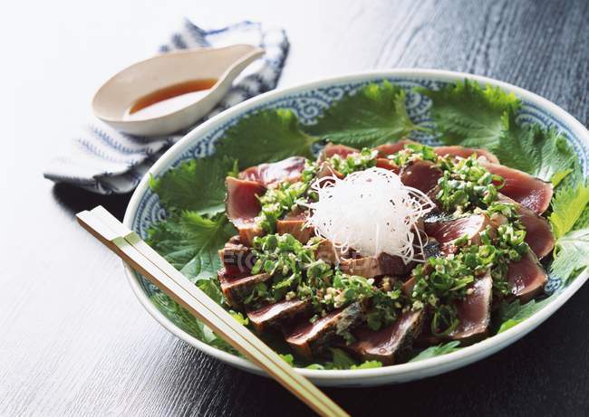 Closeup view of roasted Bonito with herbs and chopsticks — Stock Photo