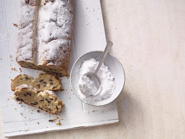 Christmas stollen with icing sugar — Stock Photo