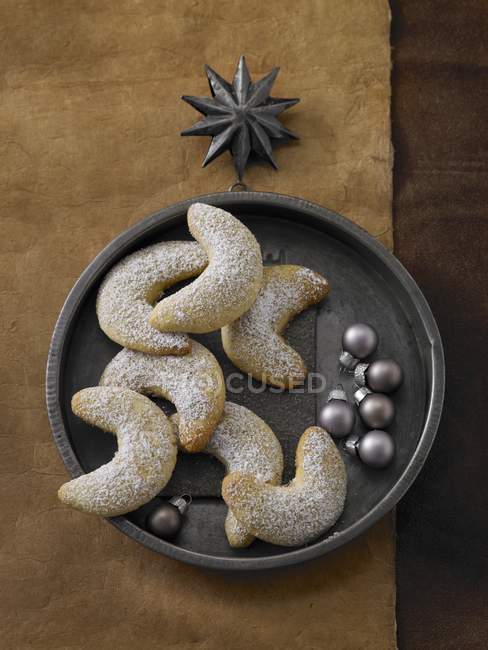 Closeup top view of vanilla crescents with baubles — Stock Photo