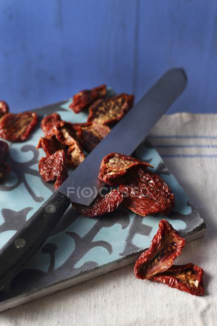 Dried tomatoes on board — Stock Photo