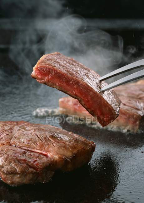 Sirloin steak on pan — Stock Photo