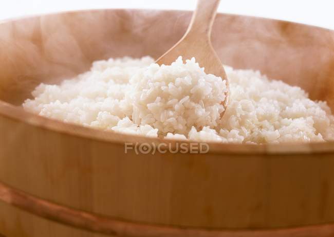 Wooden steamer pot with steaming rice — Stock Photo