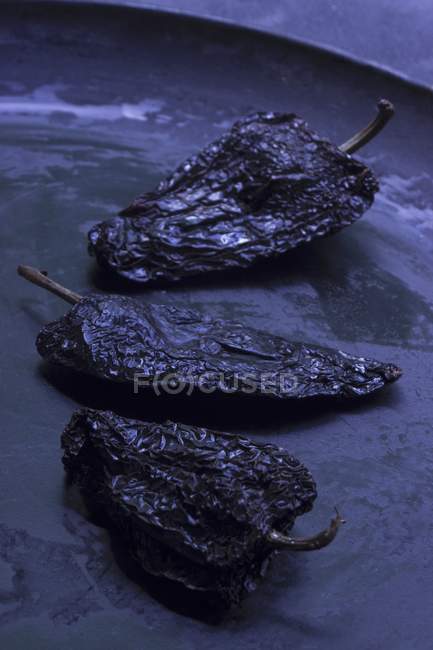 Black jalapeo chilli peppers — Stock Photo