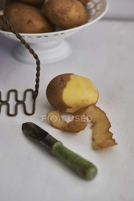 Partially peeled potato — Stock Photo