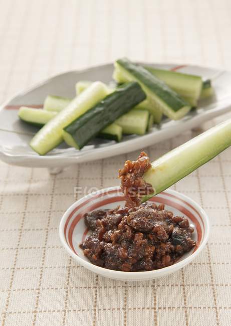 Cucumber with moromi miso  on white plates over tablecloth — Stock Photo