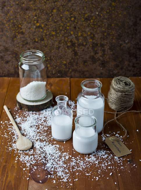 Coconut milk on woden surface — Stock Photo